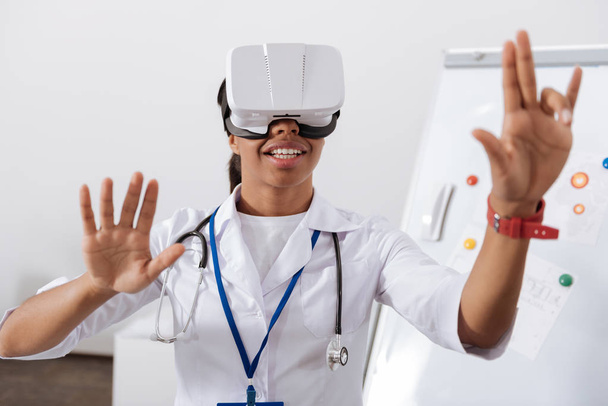 Delighted nice doctor touching the virtual screen - Φωτογραφία, εικόνα