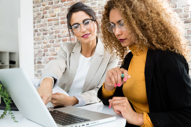 Two businesswoman working with laptop in her office. - Φωτογραφία, εικόνα