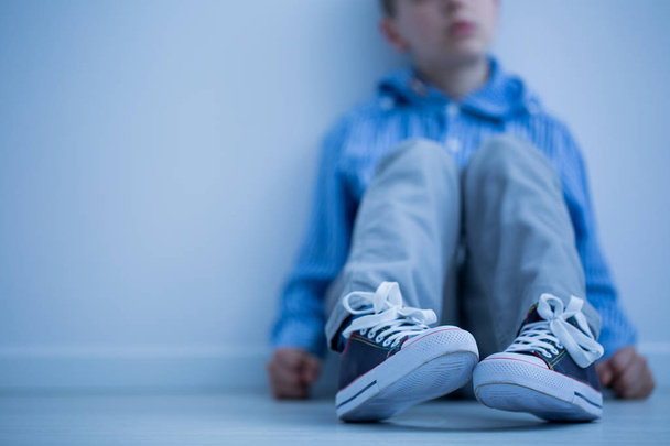 Boy sitting on a floor - Φωτογραφία, εικόνα