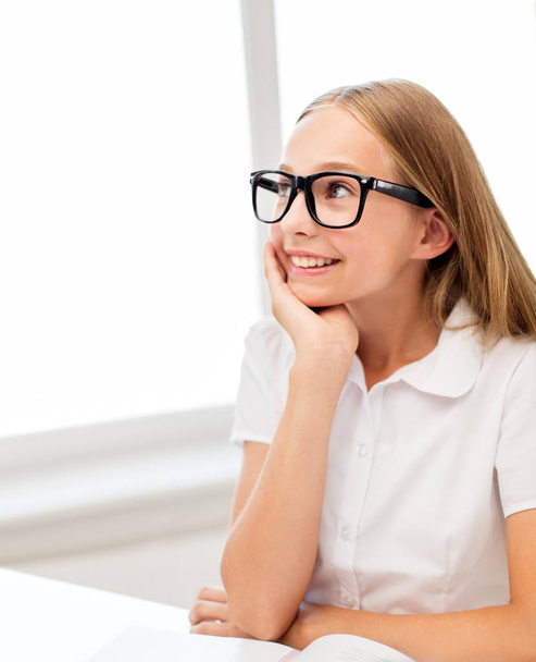 happy student girl in glasses with book at school - Φωτογραφία, εικόνα
