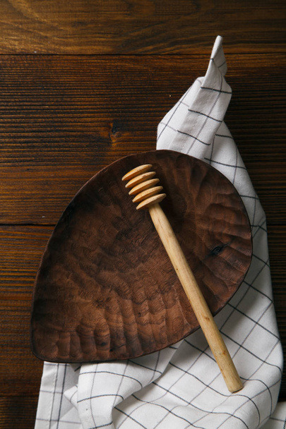 wooden plate and honey spoon - 写真・画像
