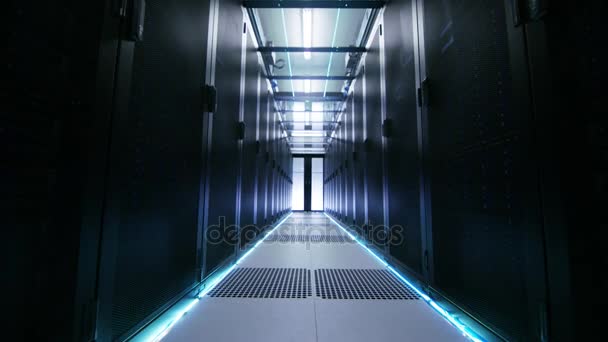 Camera Moves Through Atmospherically Illuminated Data Center with Rows of Rack Servers and Glass Ceiling. - Séquence, vidéo