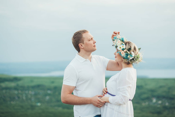 beautiful pregnant girl and her husband in the nature - Фото, зображення