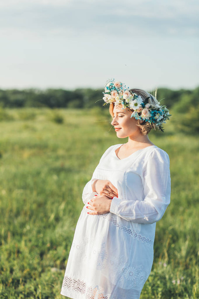 young pregnant girl in a white dress on the nature - Fotoğraf, Görsel