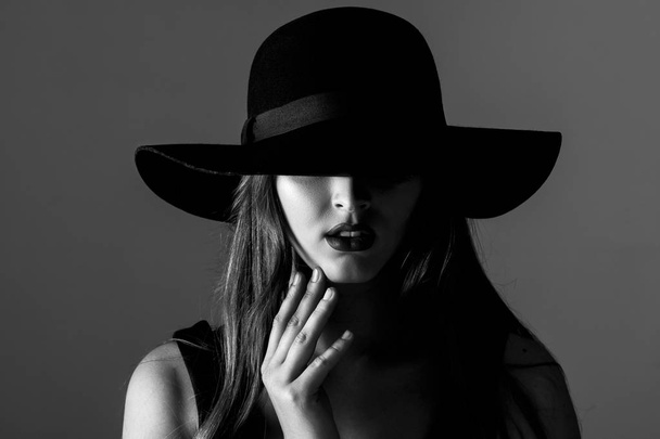 Black and white portrait of beautiful sexy woman in black hat - Zdjęcie, obraz