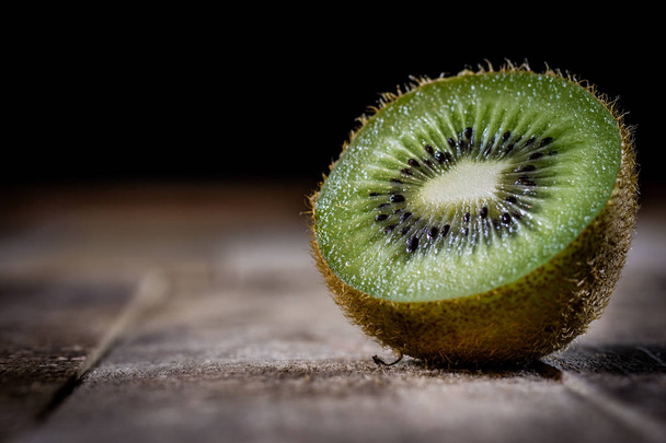Kiwi in the old kitchen on a wooden table. - Фото, зображення