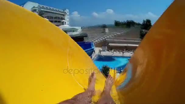 Water park, water slides, water attraction. The man is rolling on a water slide. - Footage, Video