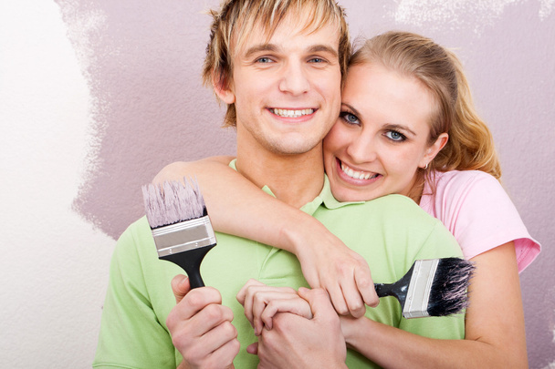 Happy young couple painting new home - Photo, Image