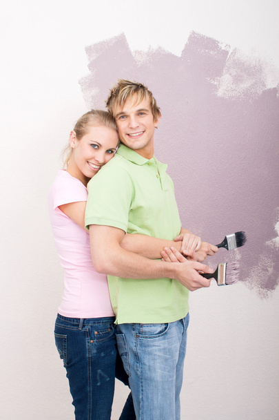 Happy young couple doing home renovation together - Photo, Image