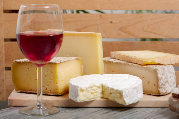 Different french cheeses with a glass of wine - Photo, Image