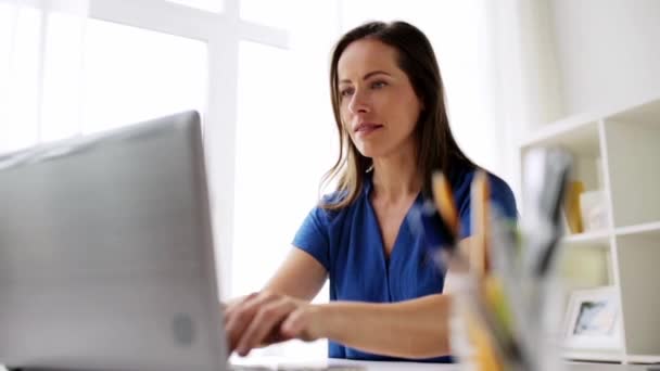 woman with laptop and notebook at home or office - Video, Çekim