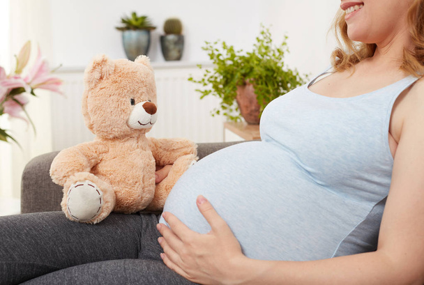 Pregnant woman with teddy bear - Photo, Image
