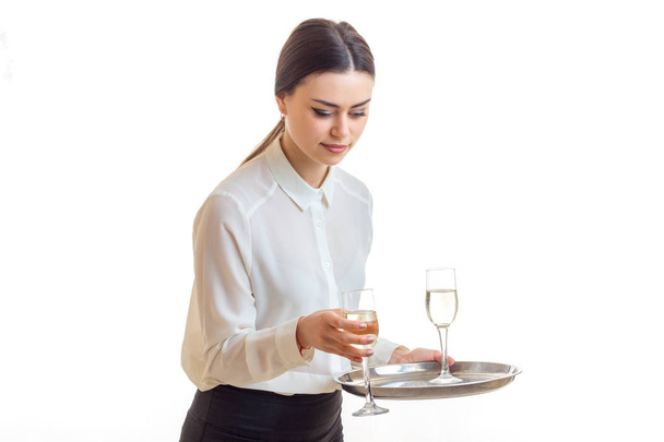 beautiful girl-waiter takes a tray of champagne with glasses - Foto, immagini