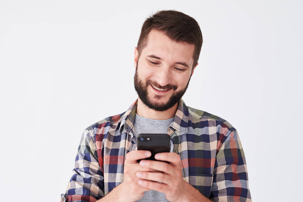Pleased man using smartphone, close-up shot - Foto, afbeelding