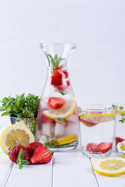 Cold fresh  homemade  lemonade with strawberry and herbs. Detox soda water - Photo, Image
