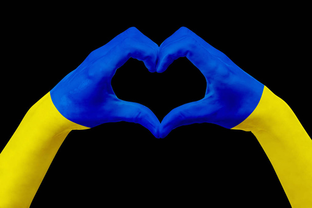 Hands flag of Ukraine, shape a heart. Concept of country symbol, isolated on black. - Fotoğraf, Görsel