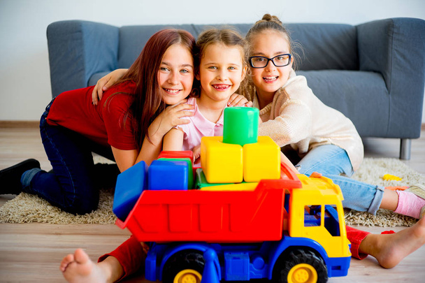 Girls with toy truck - Fotó, kép
