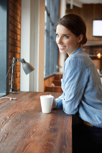 Beautiful brunette using laptop in cafe.  - Photo, image