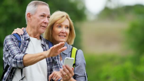  seniors navigating with smart phone - Footage, Video