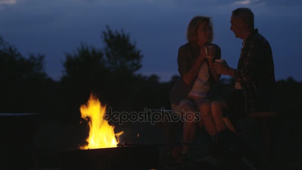 seniors sitting by the campfire - Footage, Video
