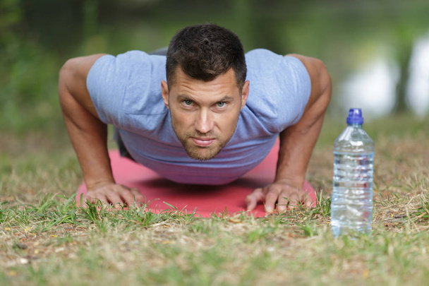handsome man exercising in park - Photo, image