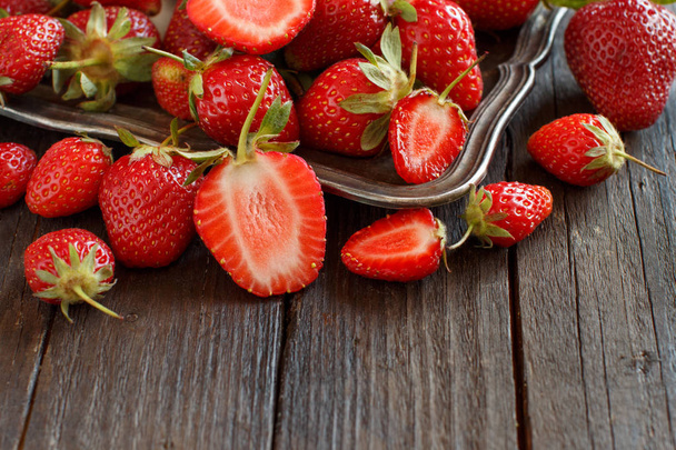 Strawberries in a tray on a wooden table - Photo, Image