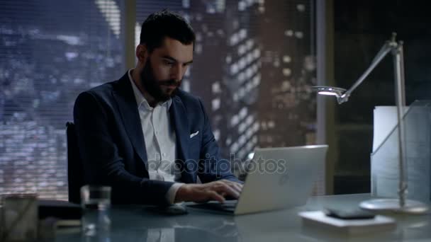 Late at Night Businessman Works on a Laptop in His Private Office with Big City Window View. - Felvétel, videó