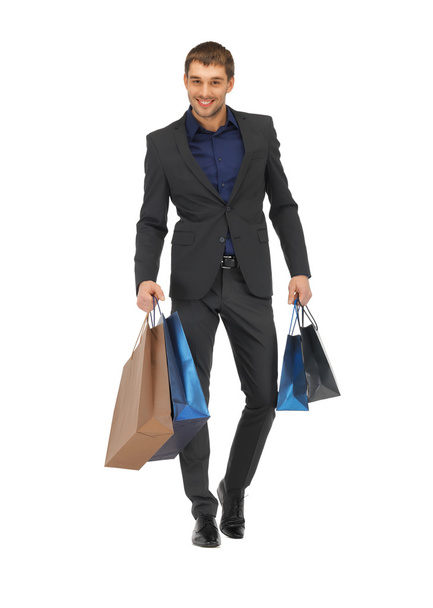 Handsome man in suit with shopping bags - Foto, imagen