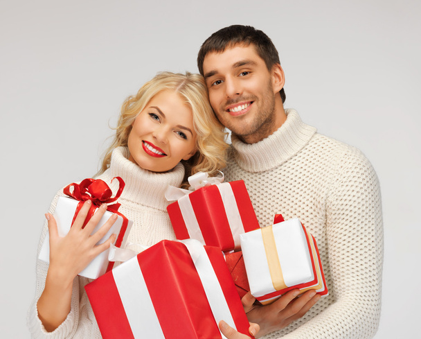 Romantic couple in a sweaters with gift boxes - Foto, imagen