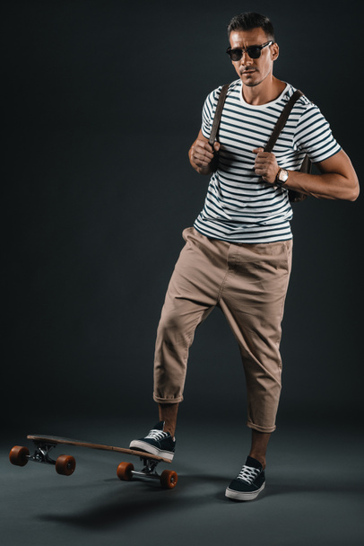 Stylish man with skateboard  - Fotó, kép