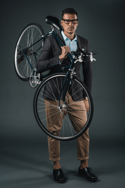 businessman in formal wear holding bicycle - 写真・画像