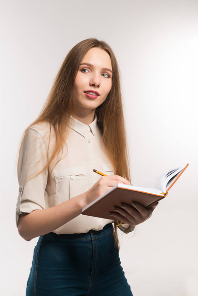 Νεαρό κορίτσι με μολύβι και στα χέρια το βιβλίο - Φωτογραφία, εικόνα