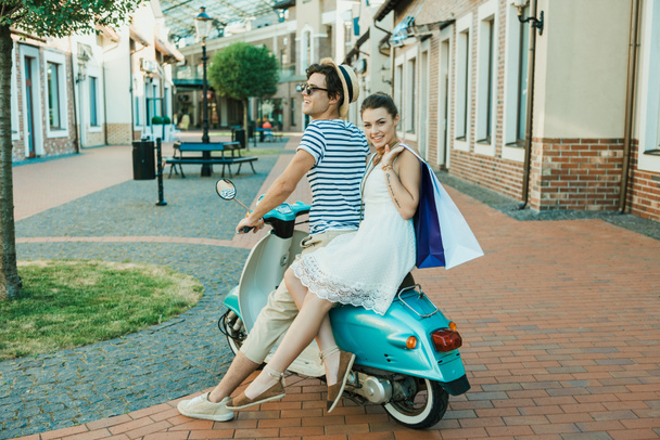 young stylish couple riding on scooter - Photo, Image