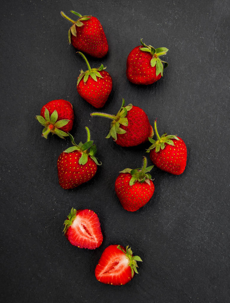 Strawberries on a black stone background - Foto, Bild