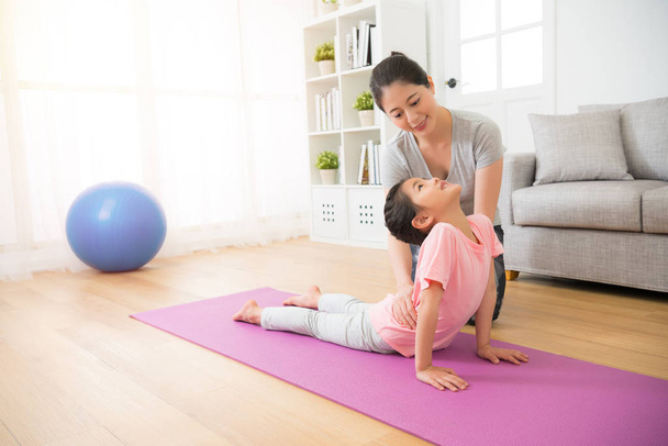 mother teaching her small girl his yoga notions - Photo, image