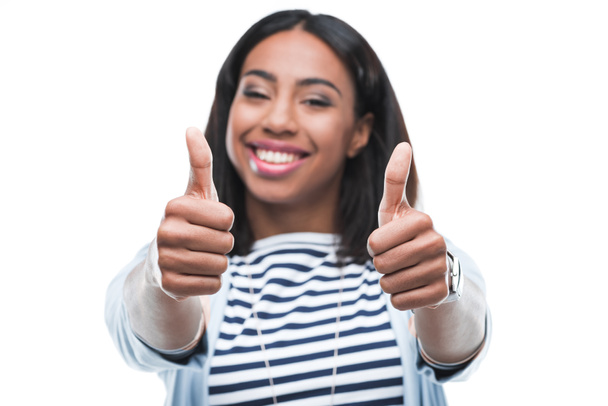 Young woman gesturing thumbs up - Photo, Image