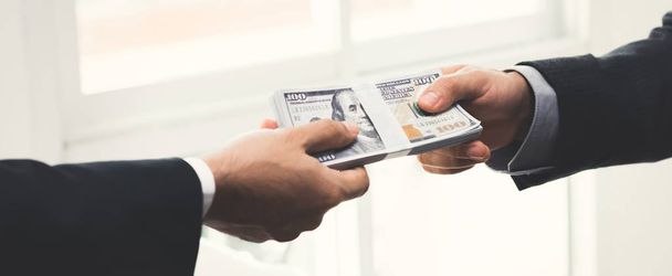 Businessman giving money to his partner - Фото, изображение