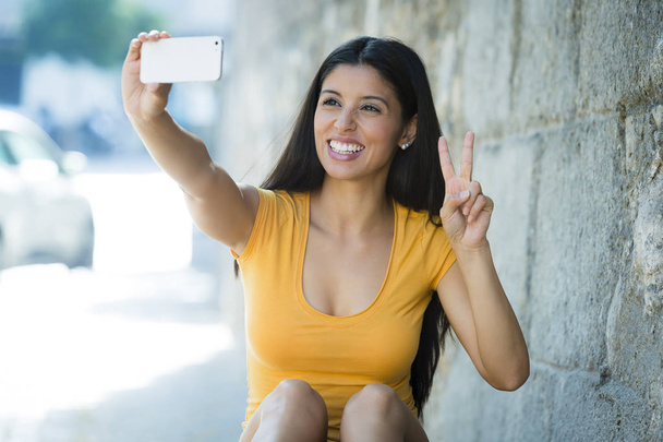 woman smiling taking selfie - 写真・画像