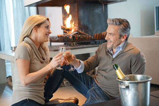 Couple at home drinking champagne - Photo, image