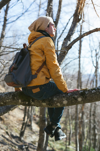 young man with backpack in forest - Foto, Imagen