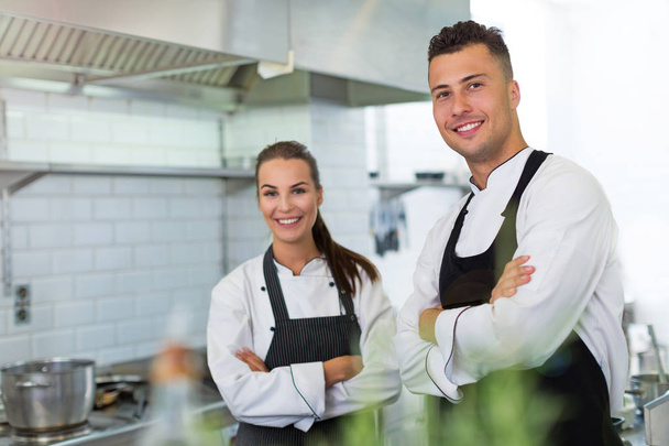 Two smiling chefs in kitchen - Zdjęcie, obraz