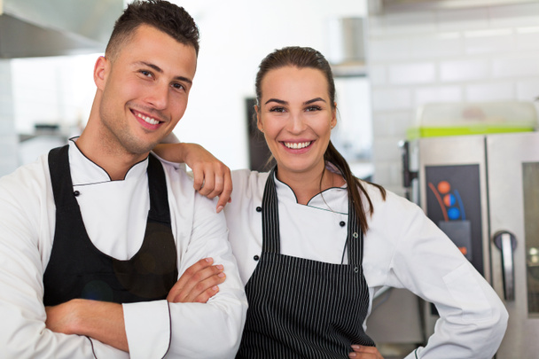 Two smiling chefs in kitchen - Photo, Image
