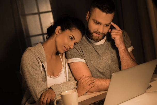 young pensive couple looking at laptop - Photo, Image