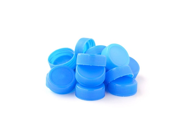 Haufen blauer Plastikflaschenverschluss auf weißem Hintergrund - Foto, Bild