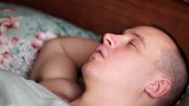 Close-up shot of young man in bed at home sleeping - Фото, зображення