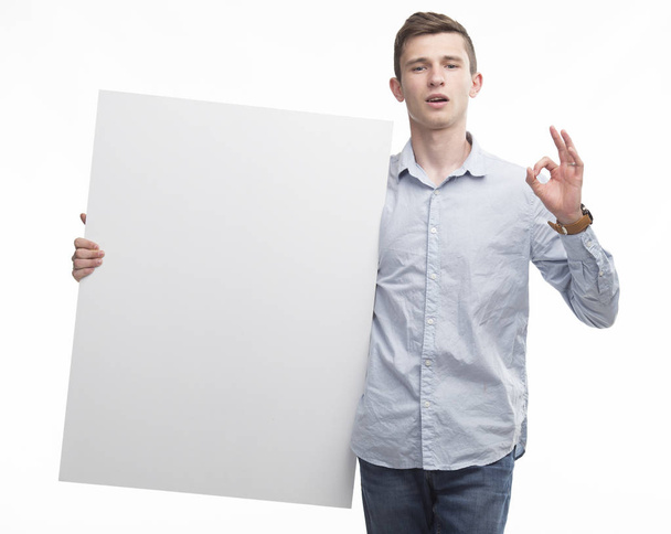 Young confident man showing presentation, pointing on placard - Photo, image
