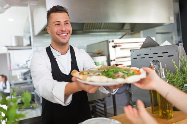Chef sonriente con pizza
 - Foto, imagen