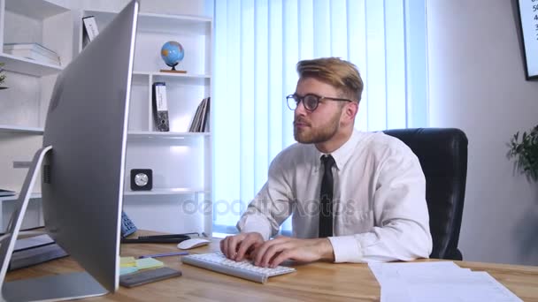 Businessman with arms raised celebrating success in office - Felvétel, videó