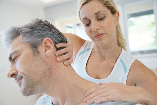 Physiotherapist massaging patient - Фото, зображення