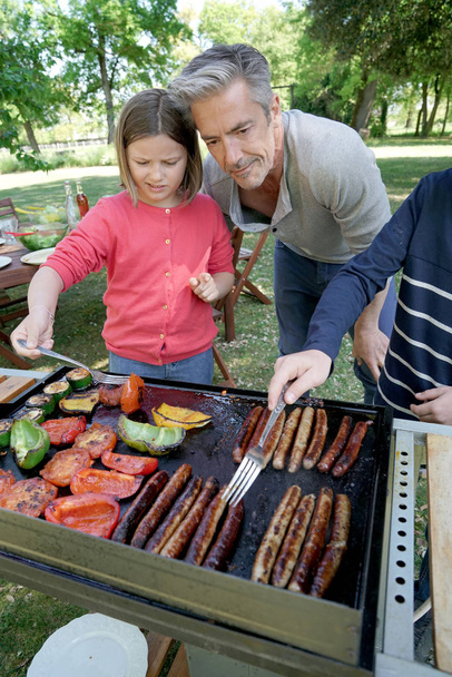 Father with kids preparing barbecue - Φωτογραφία, εικόνα